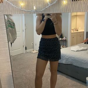 black with blue flower skirt with ruffles, size small.